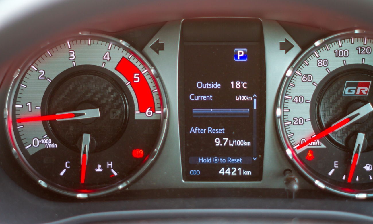 Toyota Hilux GR-S (GR-Sport) sporty analogue instrument cluster with driver info display and red accents.