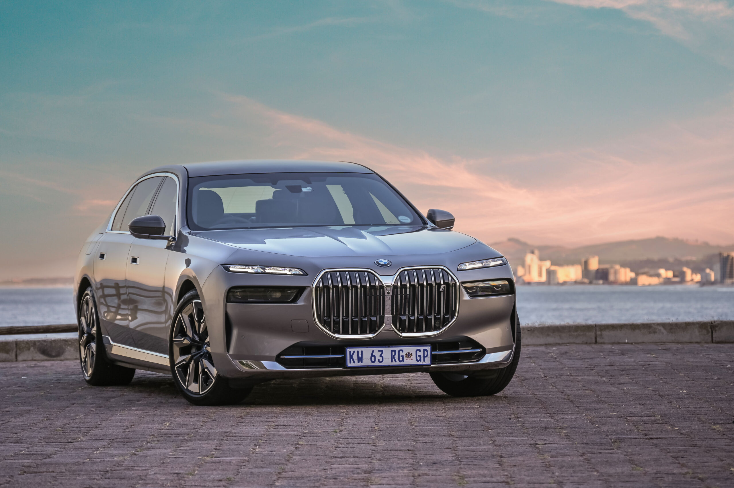 BMW 7 Series (G70) with prominent grille and split-LED light clusters.