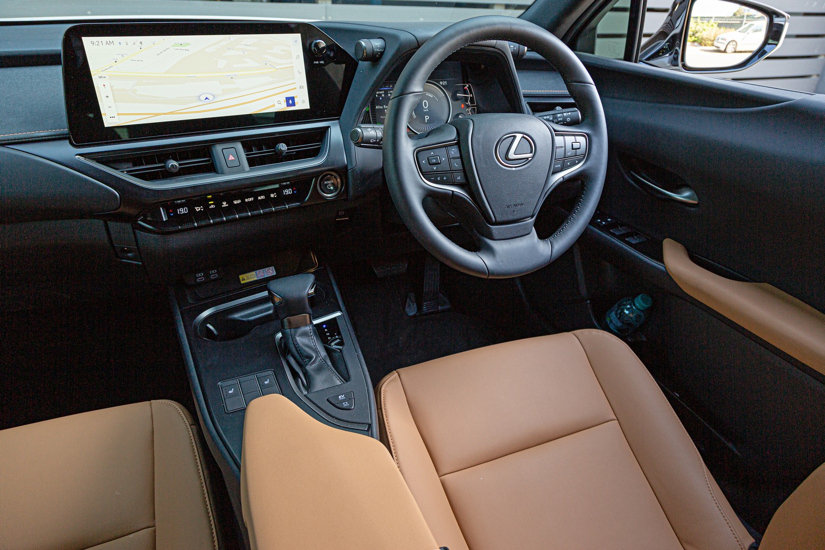 2023 Lexus UX 250h EX fascia with large touchscreen infotainment system and multifunction steering wheel.