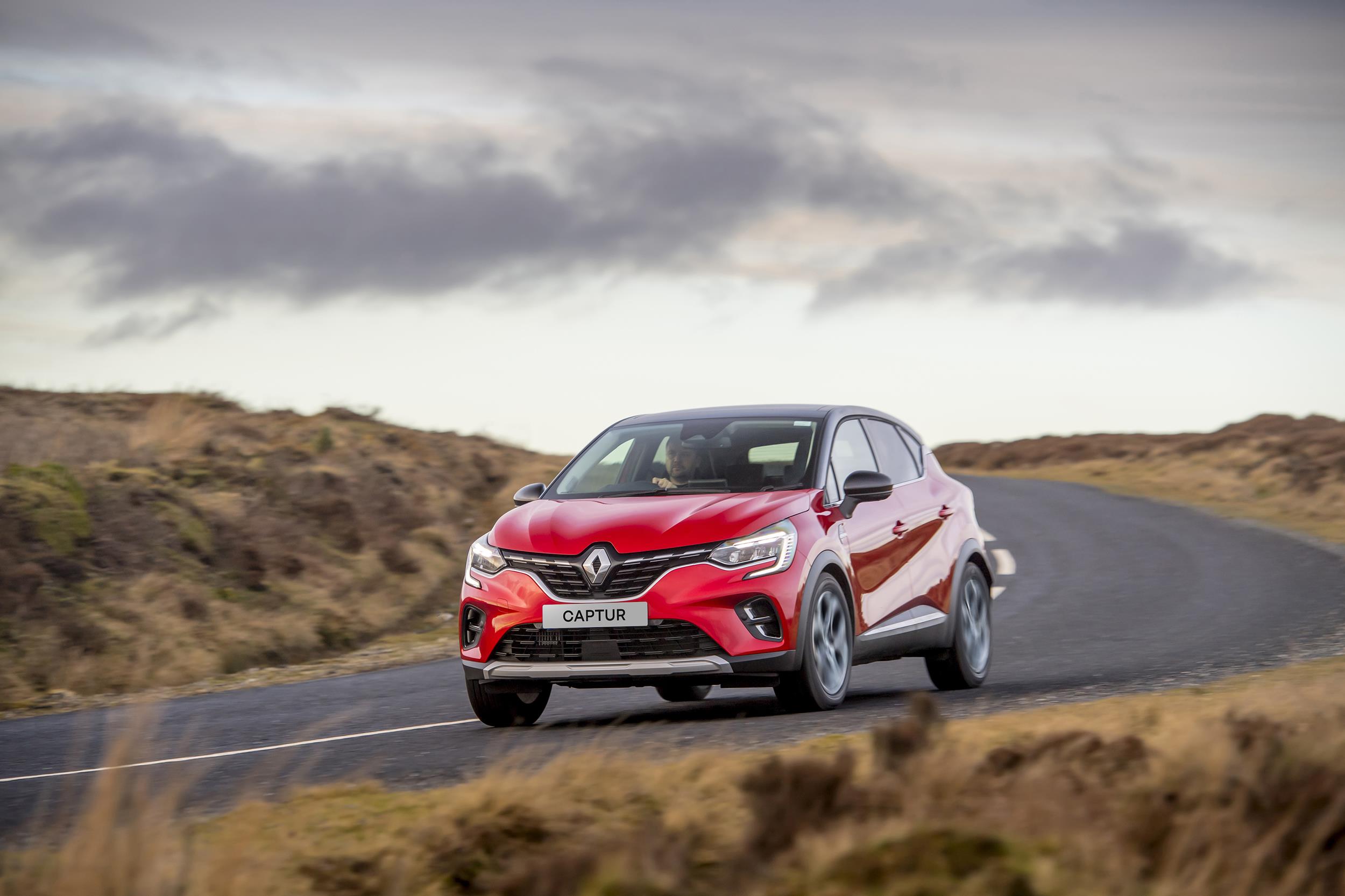 2023 Renault Captur driving on a country road. Front three-quarter view.