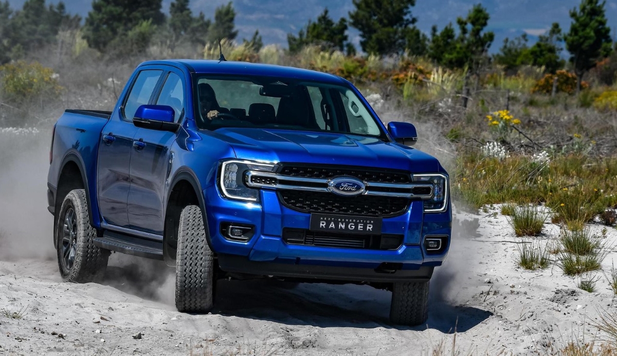 New-generation Ford Ranger double- cab 4x4 on a sandy dirt road.