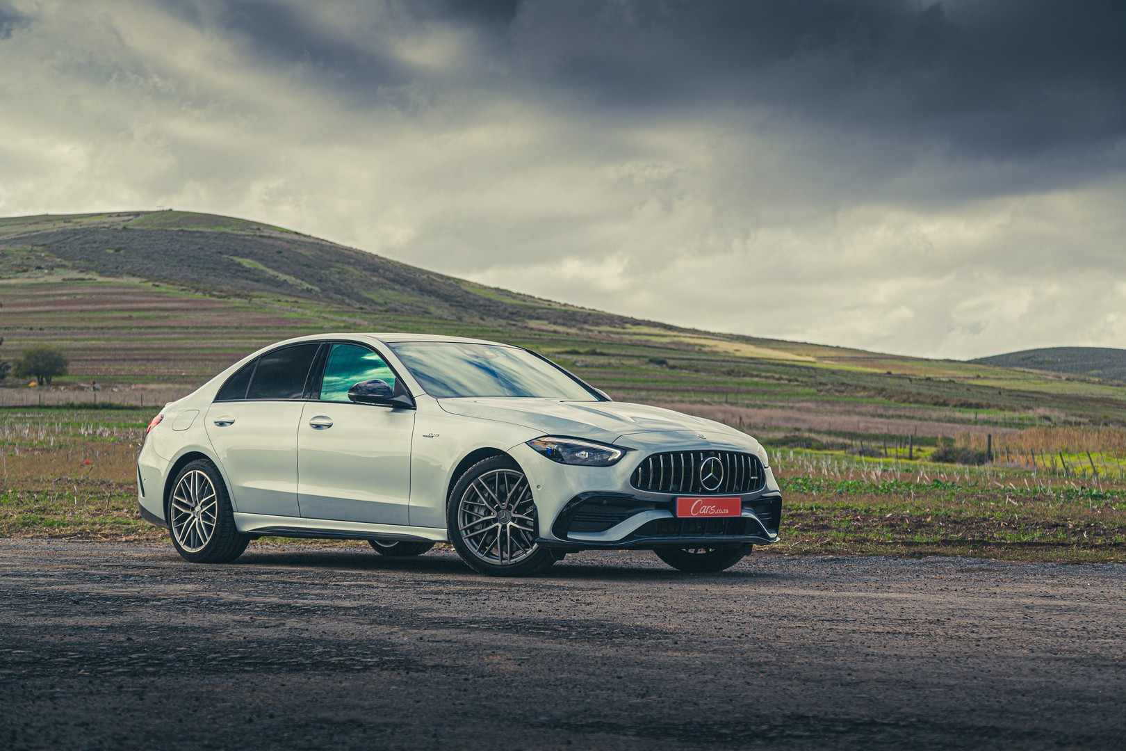 From the front, the 2023 Mercedes-AMG is distinguished from other C-Class derivatives by its sportier bumpers and Panamericana grille.