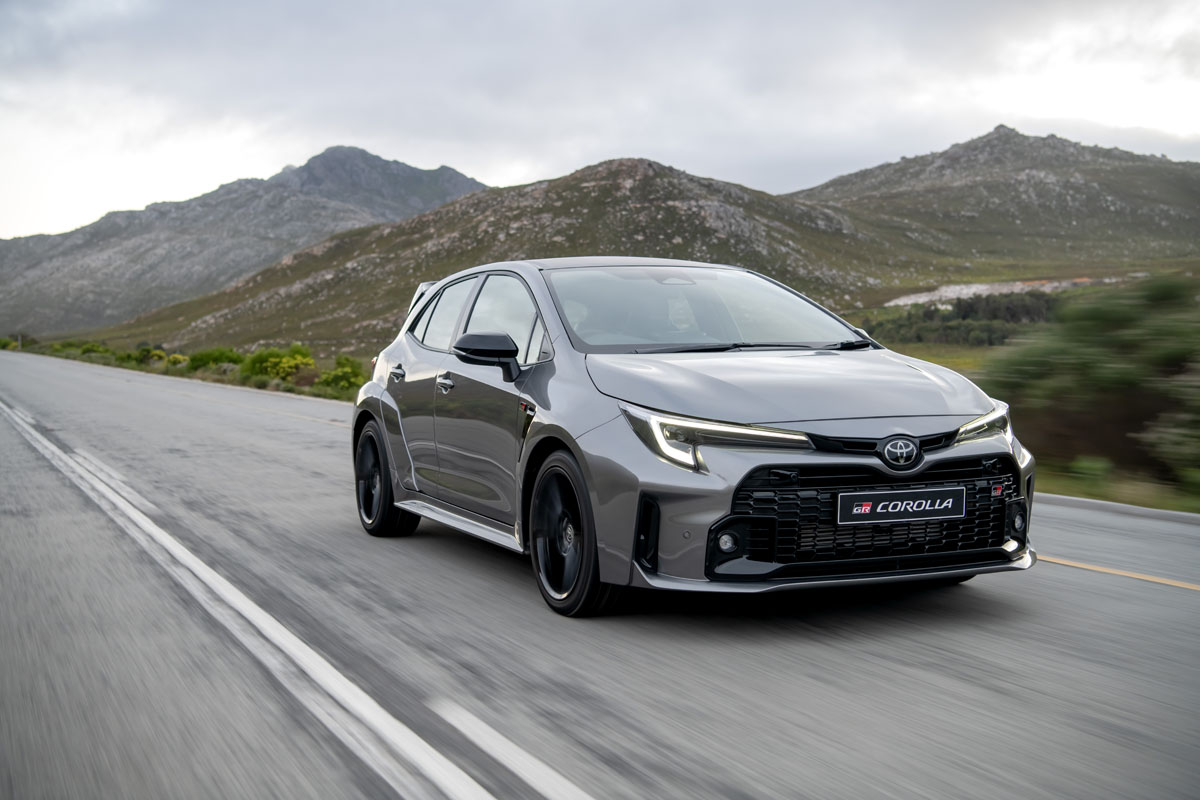 2023 Toyota GR Corolla front three-quarter tracking shot.