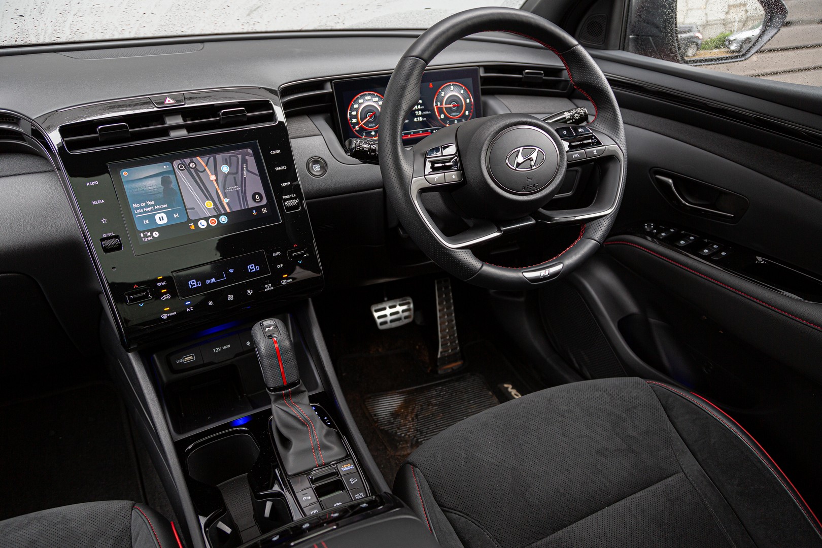 Hyundai Tucson N Line's cabin features combination trim with red accents and piano black inserts.