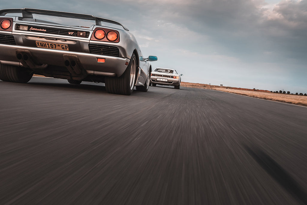 Lamborghini Diablo (left) Ferrari F512 M (left) rear tracking shot 