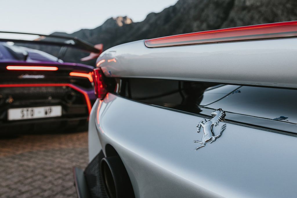 Ferrari SF90 Spider (right) and Lamborghini Huracan STO rear decks close-up.