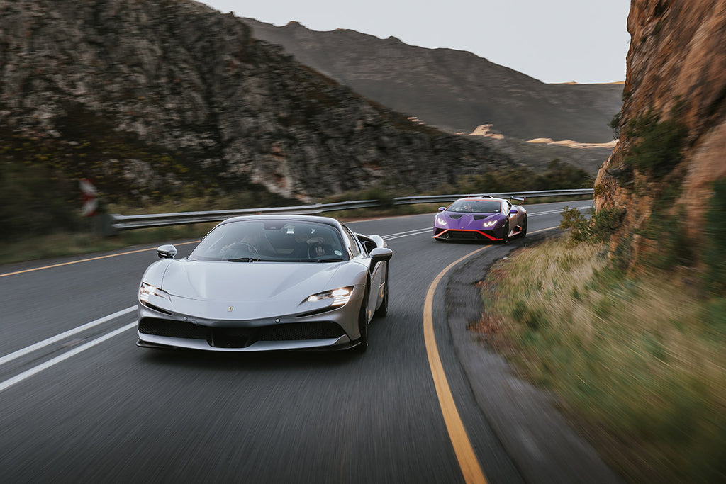Ferrari SF90 Spider (left) and Lamborghini Huracan STO front tracking shot