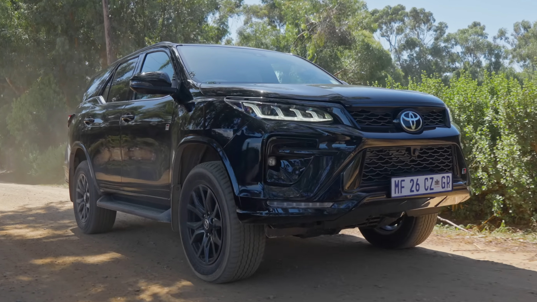 Toyota Fortuner GR-S driving on a gravel road